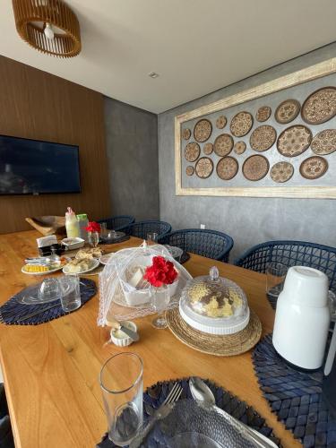 a wooden table with food on top of it at Pousada Sole - D3 Experience - Preá, CE in Prea