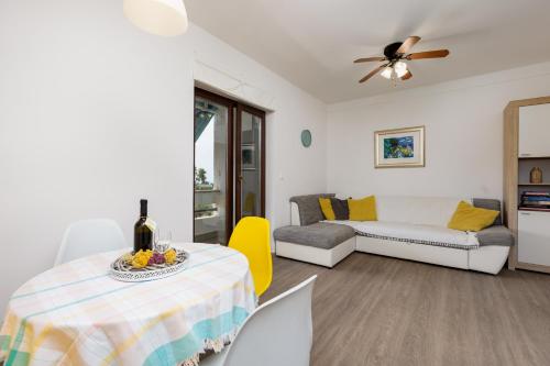 a living room with a table and a couch at Nada in Krk