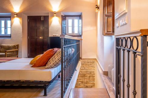 a bedroom with a bed in a room with a staircase at Host Wise - Rustic Adorable House in Old Village in Aldeia Nova