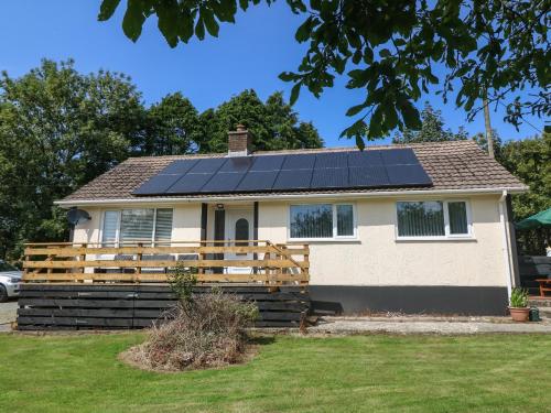 a house with solar panels on the roof at Petlyns Patch in Holyhead