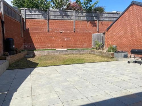 a patio in front of a brick building at Stunning 4-Bedroom Home in Basingstoke