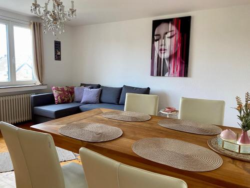 a living room with a table and a couch at Feriendomizil Mühlenblick in Xanten