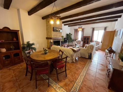 a large living room with a table and a couch at Close to Sierra Nevada Casa Rural Las Golondrinas in Güéjar-Sierra