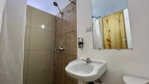 a bathroom with a sink and a shower with a mirror at Chill Boutique Hotel in Las Terrenas