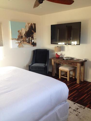 a hotel room with a bed and a chair and a desk at Iron Horse Inn in Cottonwood