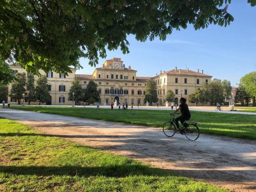a person riding a bike in front of a building at Residenza Borgo 9 in Collecchio