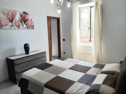 a bedroom with a bed and a dresser and a window at La casa di Nino in Portici