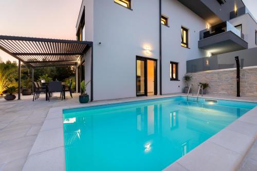 a swimming pool in the backyard of a house at Luxury Villa Adria Apartments in Krk