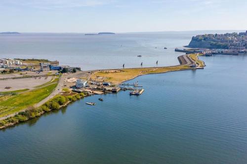 an aerial view of a beach with boats in the water at Stylish Penarth Marina Apartment in Cardiff