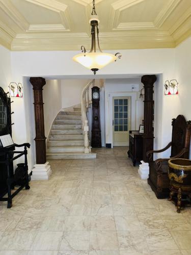 a hallway with a staircase and a chandelier at Change The World - Solar de Alvega in Alvega