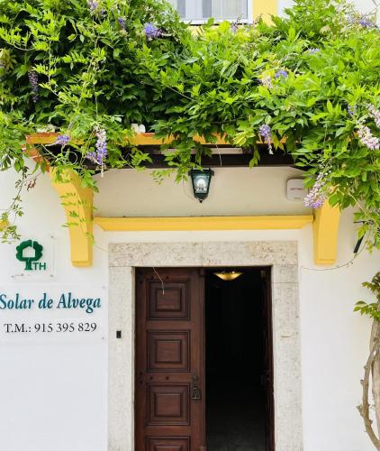 a door to a building with flowers above it at Change The World - Solar de Alvega in Alvega