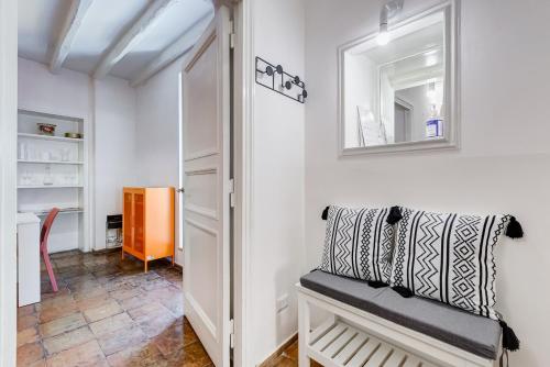 a dressing room with a bench and a mirror at BMGA l Magic Tiber 2Bdr Close to Piazza Navona in Rome