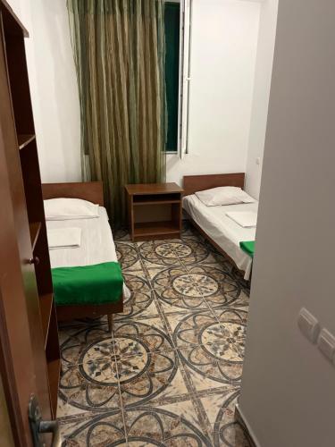 a hotel room with two beds and a doorway at Olympia in Ureki