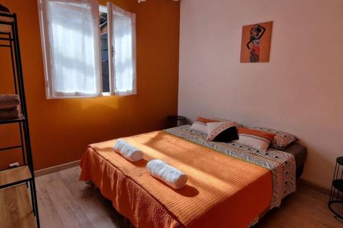 1 dormitorio con 1 cama con 2 toallas en La villa Les Terrasses sur le Port, 6 personnes, en La Possession