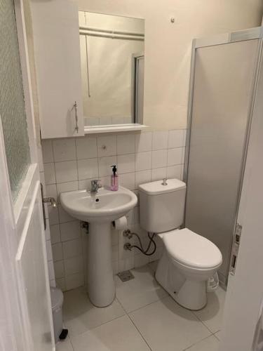 La salle de bains blanche est pourvue de toilettes et d'un lavabo. dans l'établissement Your comfort place in Beşiktaş, à Istanbul