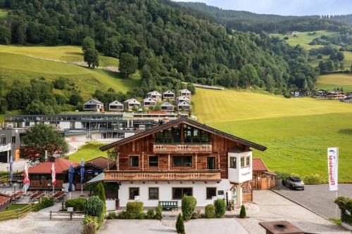 an aerial view of a house in a mountain at Apartments Fliegerbichl - Familie Voithofer in Bramberg am Wildkogel