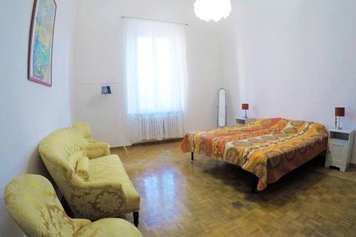 a living room with a bed and a couch at GABRY'S Cozy 3-bedroom apartment near station & city center free parking in Livorno