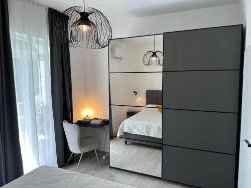 a bedroom with a bed and a dresser with a mirror at Iris apartment in Vižinada