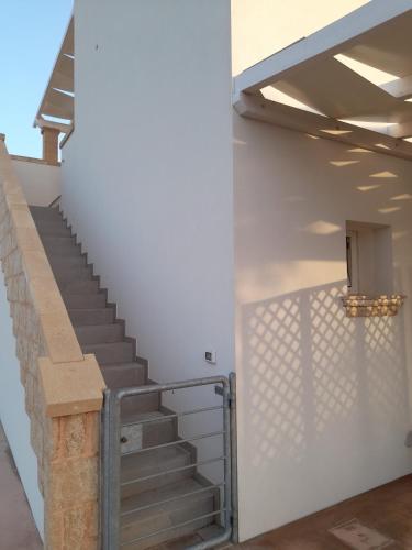 a staircase in a building with a metal railing at B&B MARRELLA in Capilungo