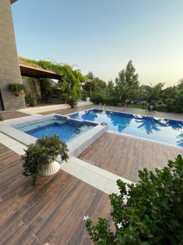 a swimming pool in the middle of a yard at Baku White Villa in Baku