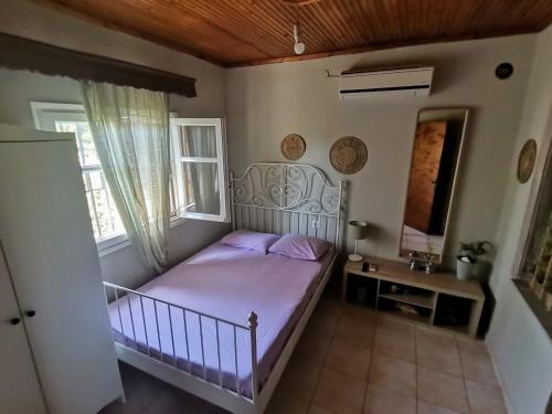 a small bedroom with a bed and a window at Country House in Sozopoli