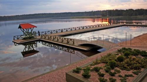 a bridge over a body of water at Osada Jaćwingów in Gołdap