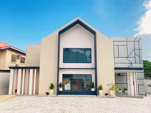 a large white building with a large window at Knightsbridge Hotel & Suites in Abuja