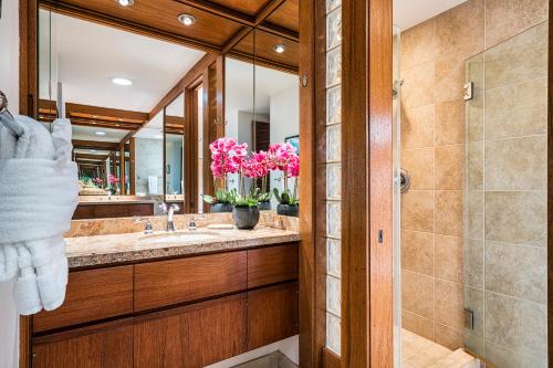 a bathroom with a sink and a mirror at Mauna Lani Terrace J101 in Waikoloa