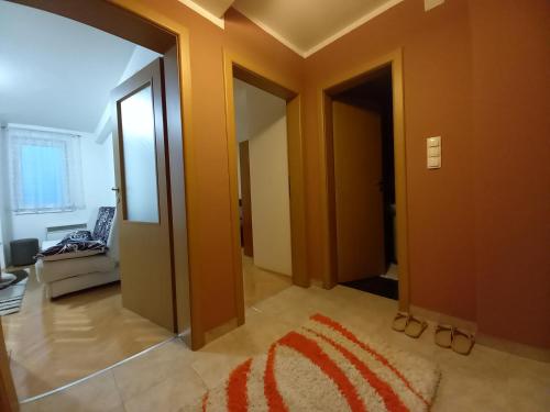 a hallway with two doors and a rug on the floor at Venus Apartman in Brčko