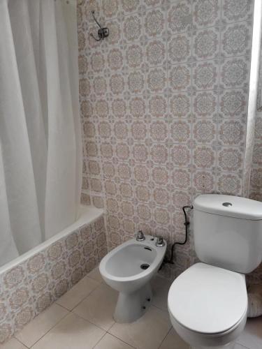 a bathroom with a toilet and a shower and a sink at Virgen de los desamparados in Puerto de Sagunto