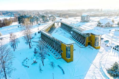 an aerial view of a building in the snow at Osada Jaćwingów in Gołdap