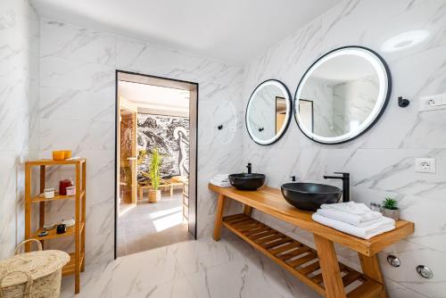 a bathroom with a sink and two mirrors at Villa A in Novigrad Dalmatia