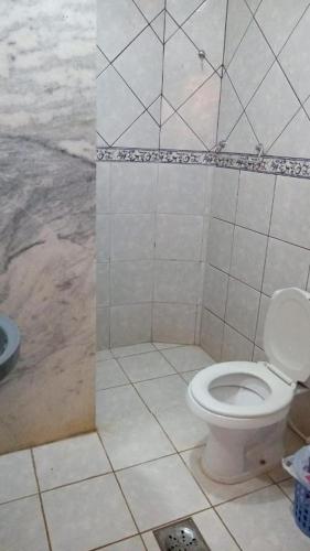 a bathroom with a white toilet and a shower at Beiruth Hotel in Brasília