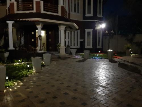 a house at night with a cobblestone driveway at Royal Feather in Tirunelveli East