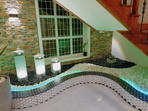 a room with a bath with candles and a window at Royal Feather in Tirunelveli East