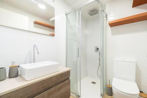a bathroom with a sink and a glass shower at Loft Plaza España in Vigo