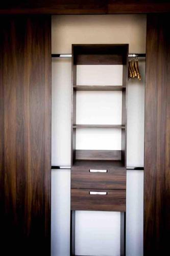 an empty closet with wooden walls and wooden shelves at Luxury Flat In Guadalajara in Guadalajara