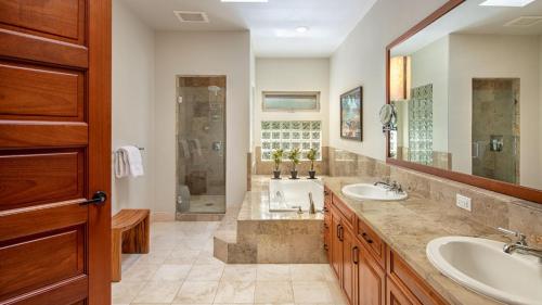 a bathroom with two sinks and a shower at Mauna Lani Villages 407 in Waikoloa