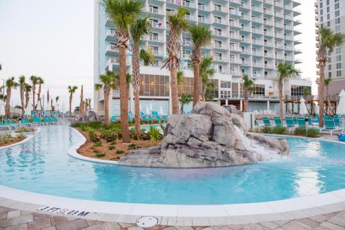 a pool at a resort with a rock in the middle at Fairfield by Marriott Inn & Suites Pensacola Beach in Pensacola Beach