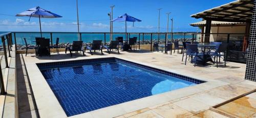 a swimming pool with a view of the ocean at Flat na praia de iracema,vista mar 606 in Fortaleza