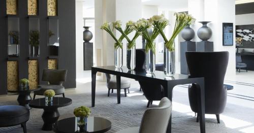 a room with a table with vases of flowers on it at InterContinental Marseille - Hotel Dieu by IHG in Marseille