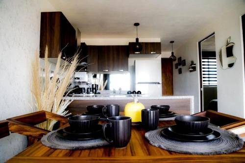 a kitchen with a table with black dishes on it at Comfort Flat In Guadalajara in Guadalajara