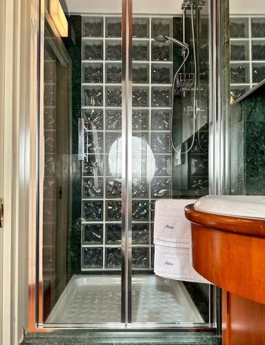 a shower with a glass door in a bathroom at Iblu Rooms in Termoli