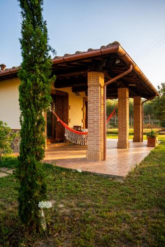 a pavilion in a garden in front of a house at Agriturismo Anfora della Vita in Massa Marittima