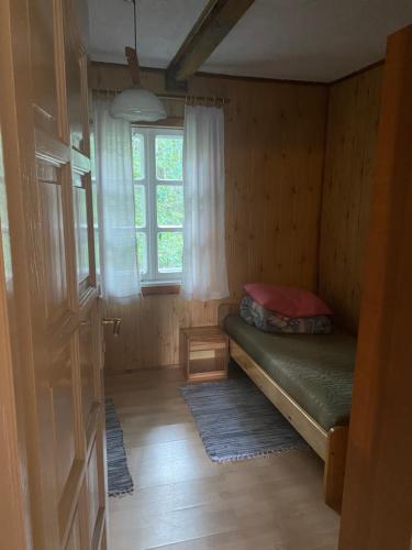 a small room with a bed and a window at AGRO-CHATKA in Myszyniec