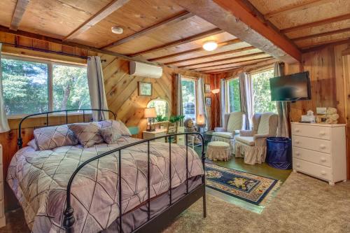 a bedroom with a bed in a room with wooden walls at Rustic Bandon Log Cabin on 5 Acres of Woodlands! in Bandon