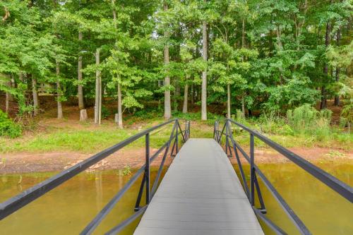 a bridge over a river with trees in the background at Peaceful Lake Hartwell Gem with Boat Dock in Martin