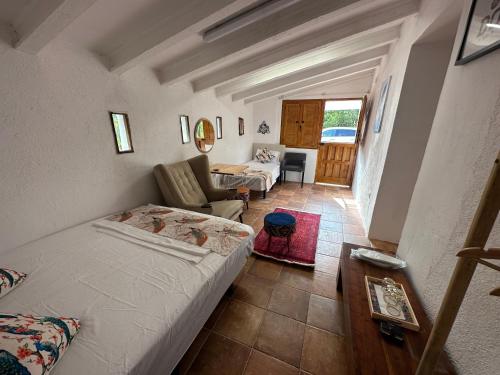 a bedroom with a bed and a living room at Hidden garden Central and quiet rest in Barcelona
