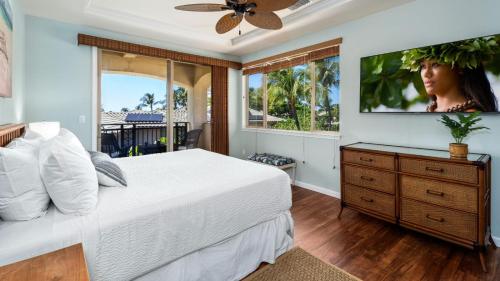 een slaapkamer met een bed en een tv aan de muur bij Mauna Lani Fairways 1601 in Waikoloa