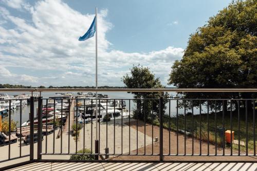 a flag on a flag pole in a marina at Exklusive Ferienwohnungen an der Havel in Werder